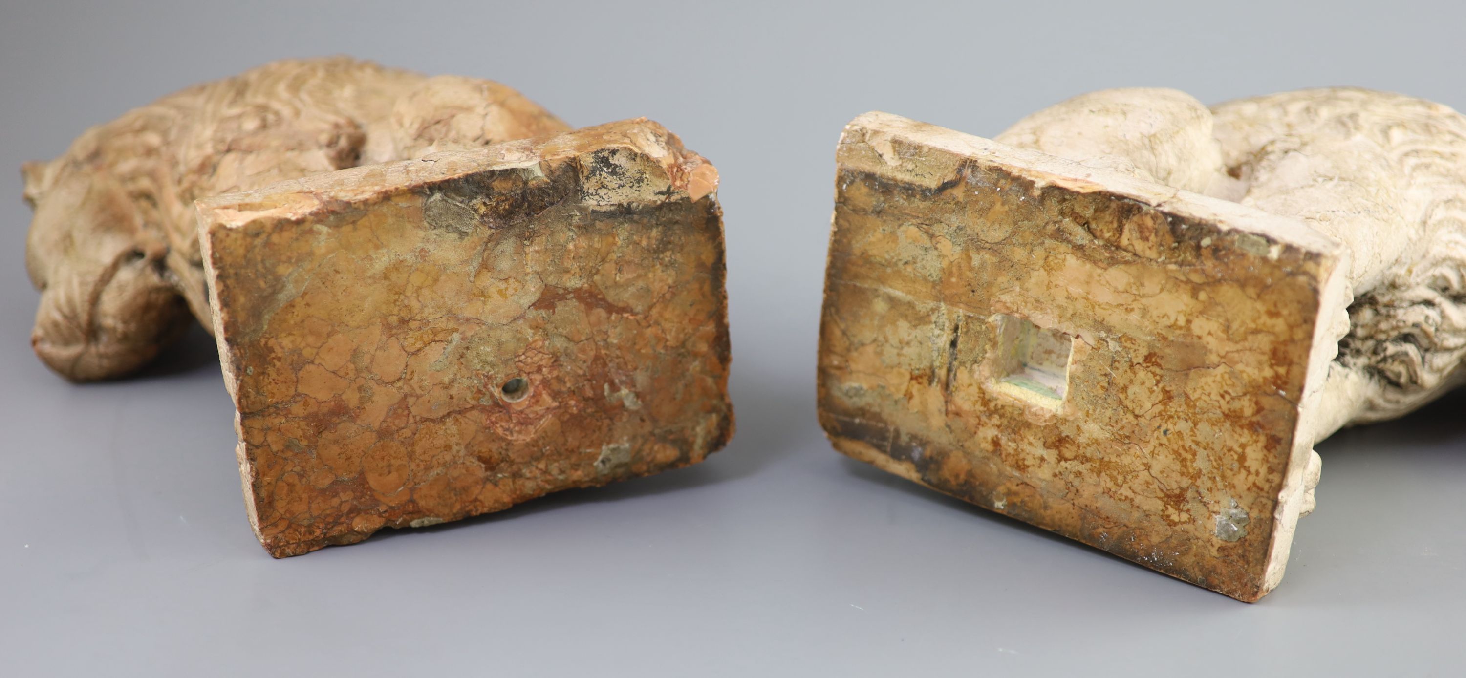 A pair of European pink marble seated lions, 18th century or earlier, 25cm high